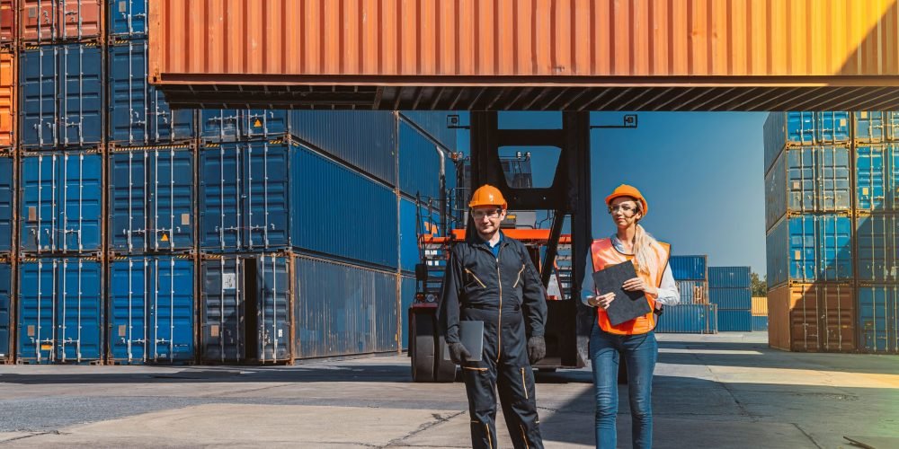 Workers checking logistic cargo container Import and Export industries.